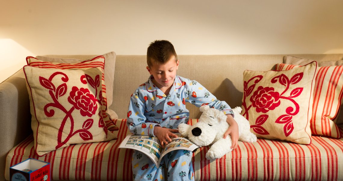 child-pajamas-reading-sofa