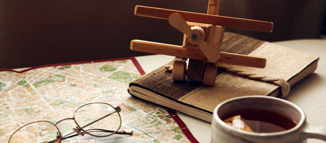 Wooden plane and world map