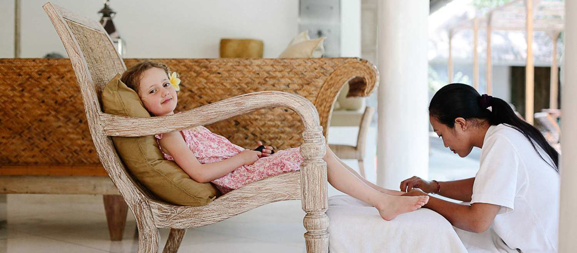 A little girl enjoys her relaxing pedicure moment at Villa Sungai in Thailand