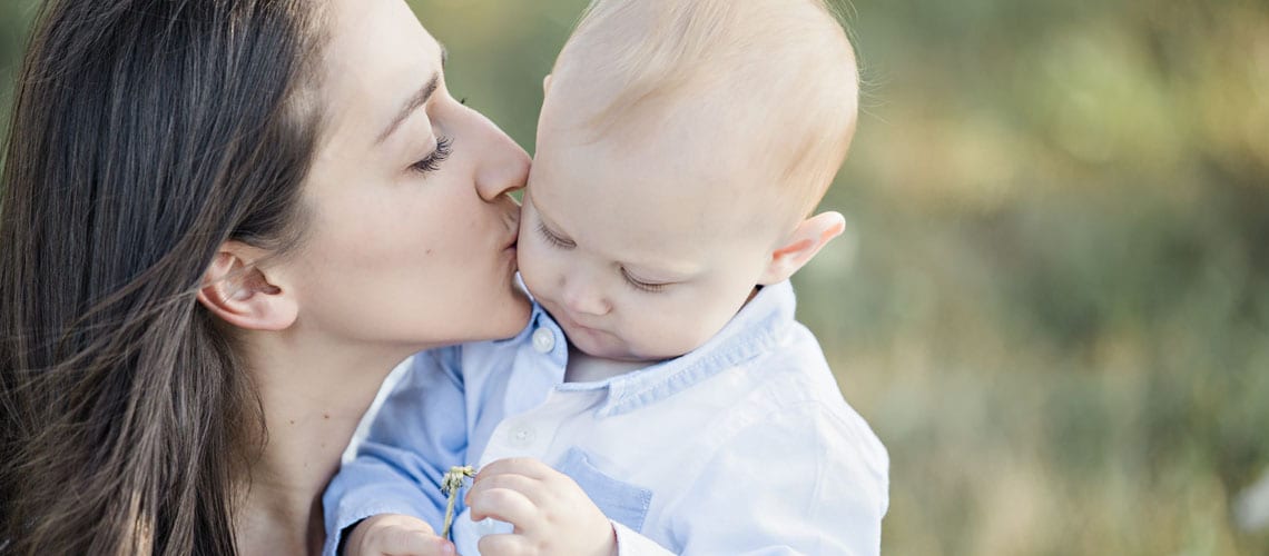 mom-gives-her-baby-a-kiss