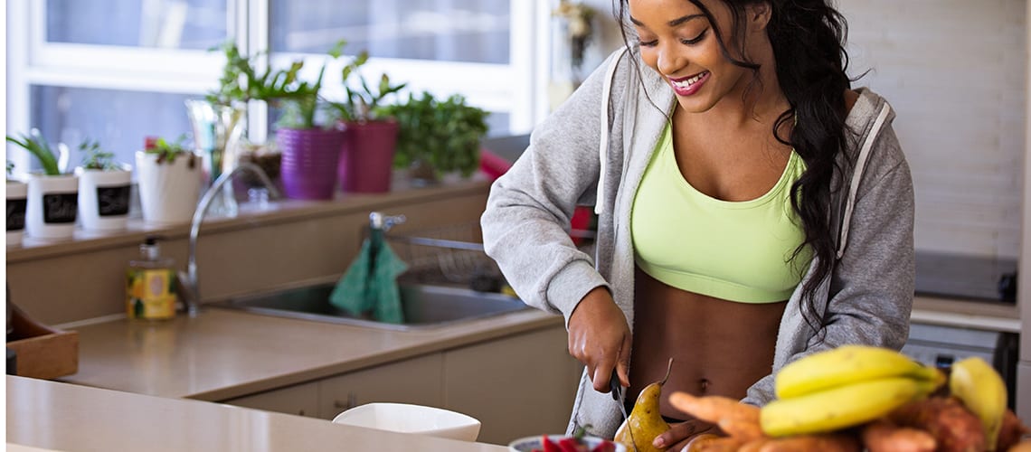 sporty-woman-cutting-fruit