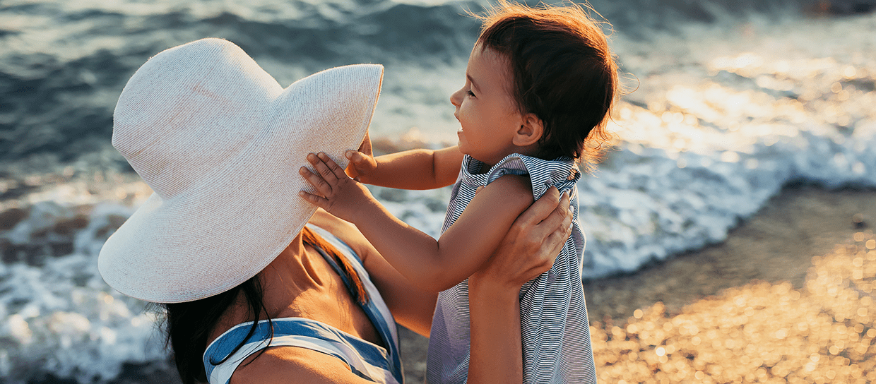 mother-holding-daughter-beach